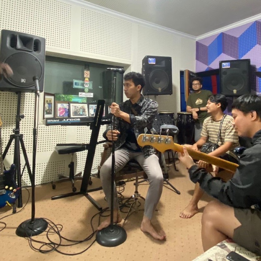 A recording session in progress in a small studio